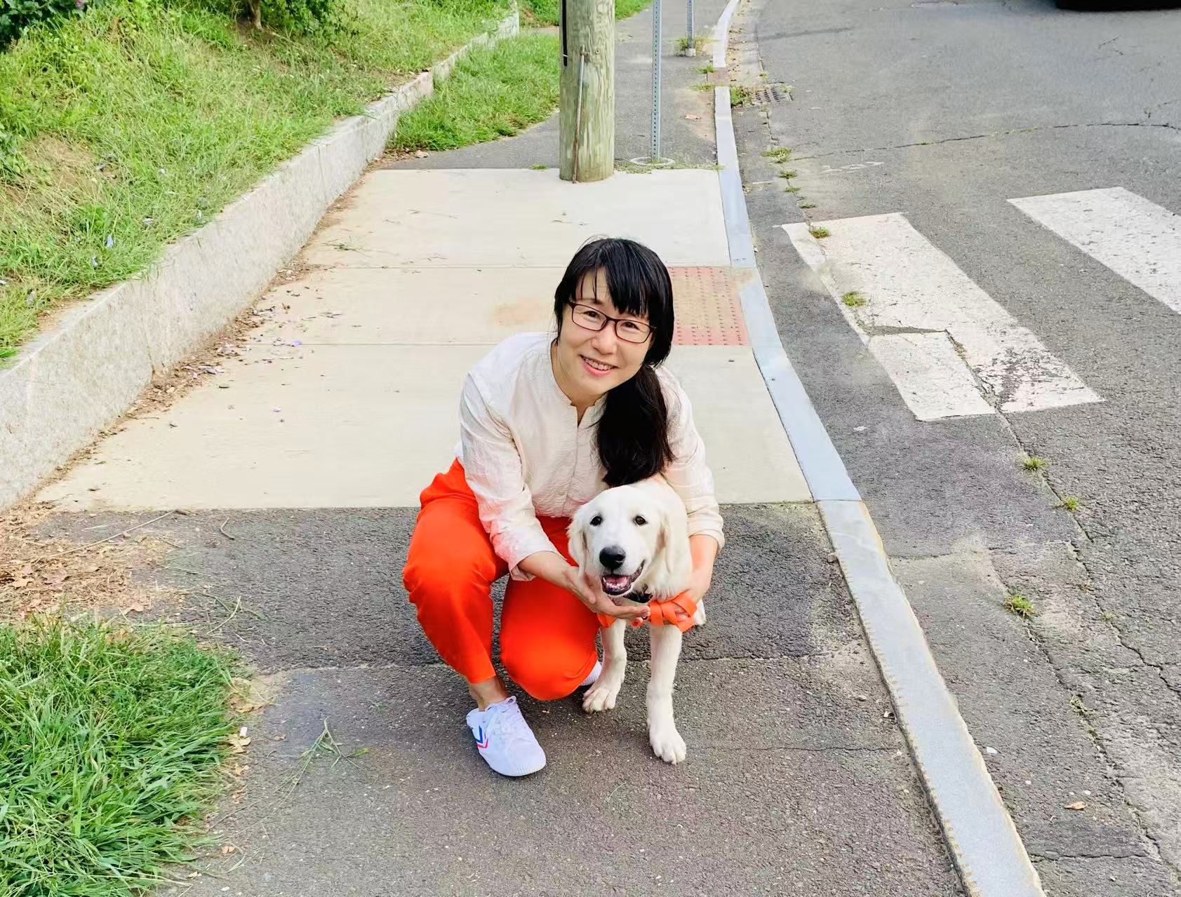 Portrait of Professor Ling Zhang with a puppy